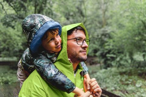 a father and son in the rain wearing rain coats