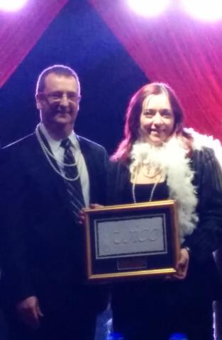 Laura and Phil accepting the gold flame award